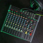 DJ operating Citronic CMC-16 16-channel mixer during live event performance